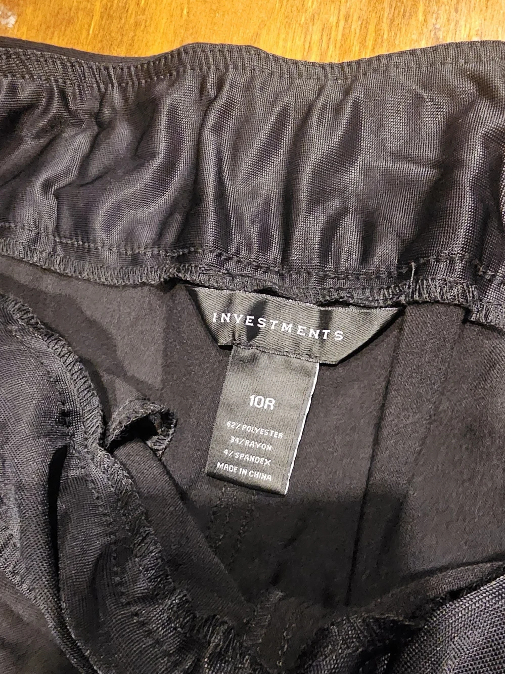 C3, The product is a pair of black dress pants for women by the brand Investment
